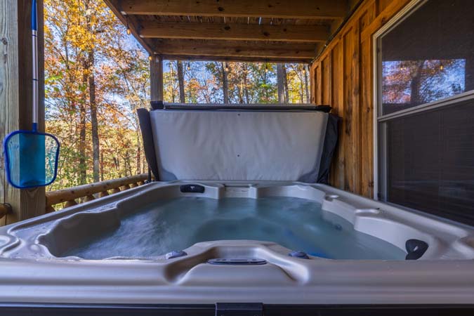 Lower deck with covered hot tub at Little Pine Cabin