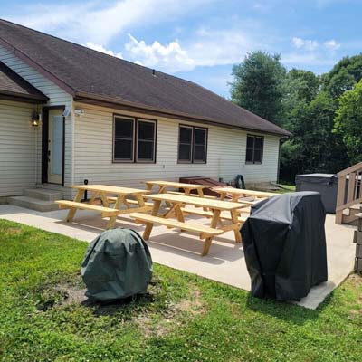 picnic tables and grill on patio