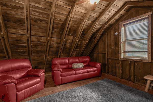 red leather loveseat and seat